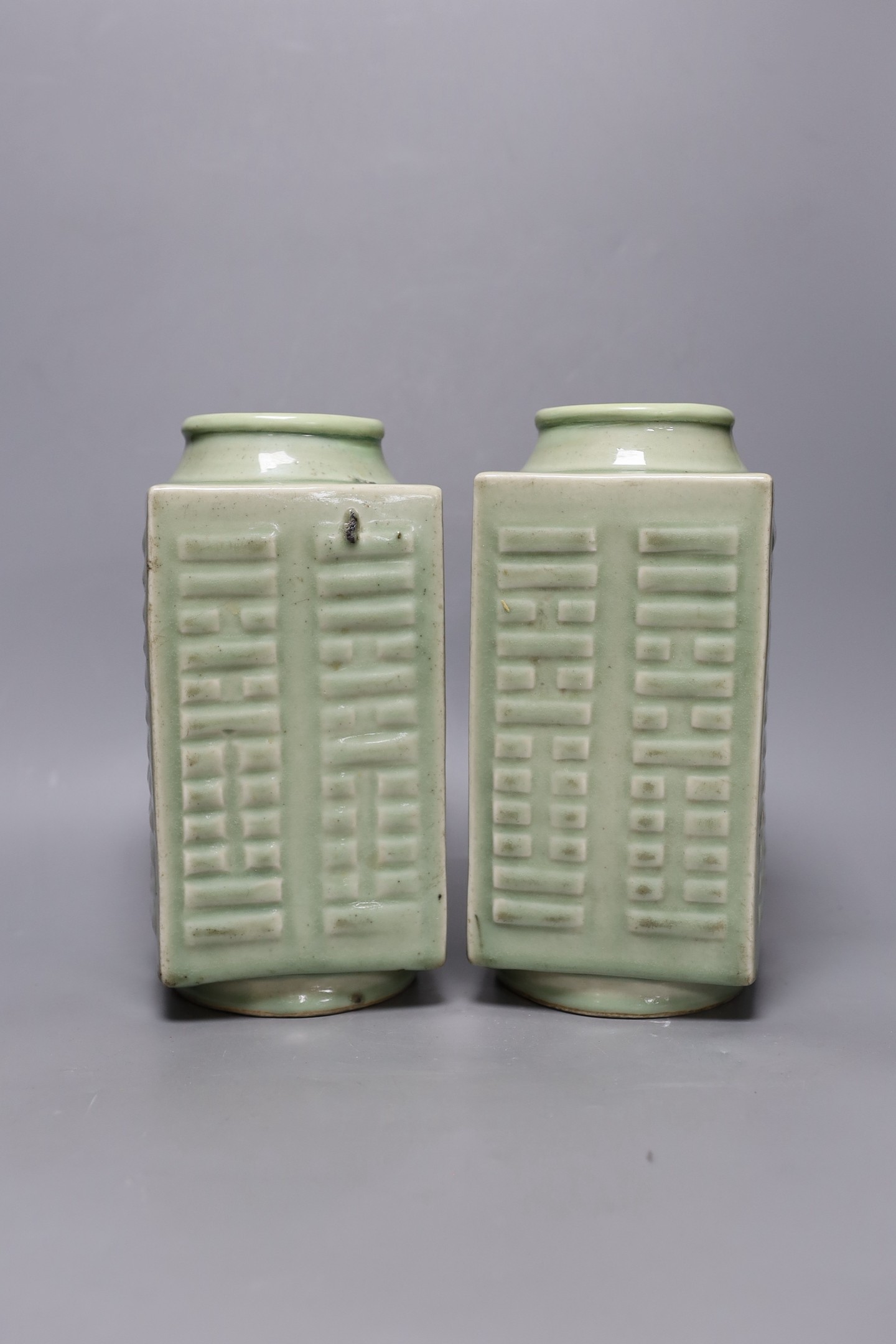 A pair of early 20th century Chinese celadon glazed eight trigrams cong vases, 25cm